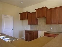 Open kitchen with tall cabinets.. and lengthy countertop space.