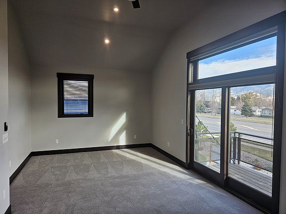 Living Area/Bedroom, 12' ceilings, windows on each side, ceiling fan, & french door w/large window above opening to patio.
