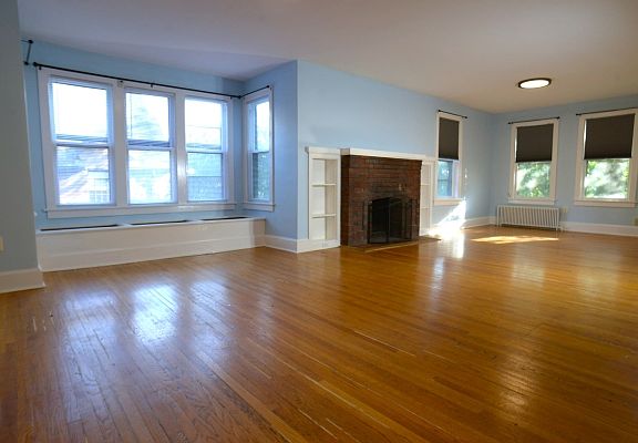 Living area with bench seat and hardwood floors.