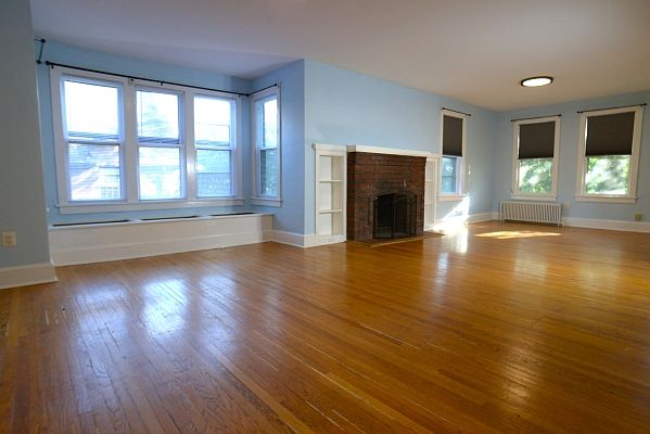 Living area with bench seat and hardwood floors.