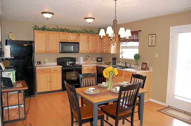 16x12 eat-in kitchen, laminate flooring, upgraded cabinets, appliances stay.