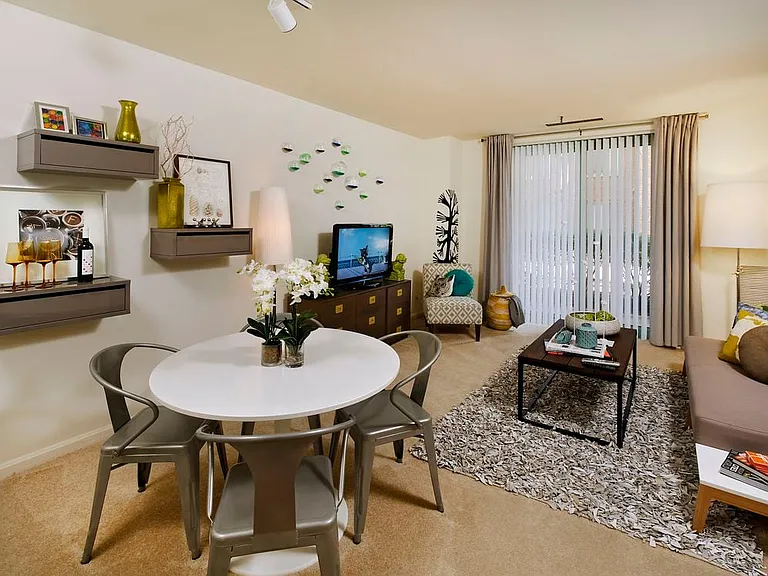 Classic Package living and dining area with carpeted floor and balcony