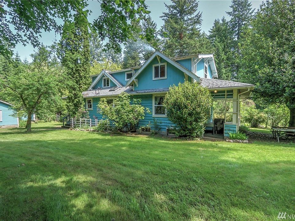 Expansive lawn and mature gardens surround the charming farm house.