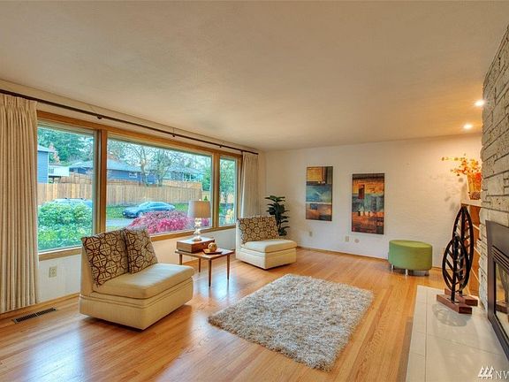 Large picture window lets in abundant light and attractive refinished original hardwood floors.  Propane fireplace for extra heat on those cool days