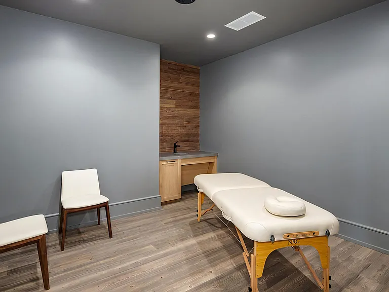 Serene Massage Space Featuring Wood-Trim Sink Area and Soft Lighting