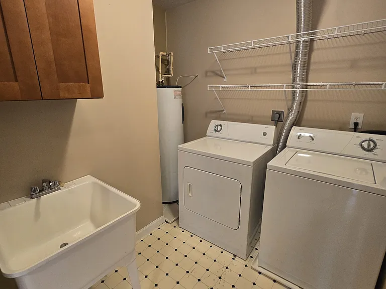 Huge laundry and utility room boasts full sized washer/dryer, extra large water heater, laundry tub, storage, and HVAC. Tons of storage space!