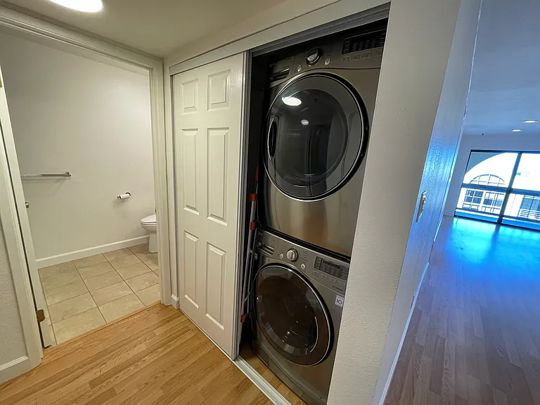 Washer and Dryer located with a view of the patio, and the fireplace.