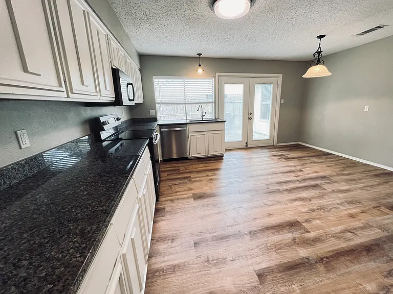 Double french door leading to the large backyard.