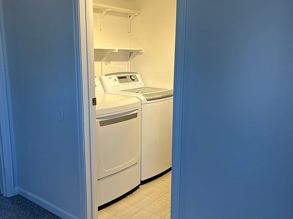 Bedroom with ensuite bathroom with washer and dryer.