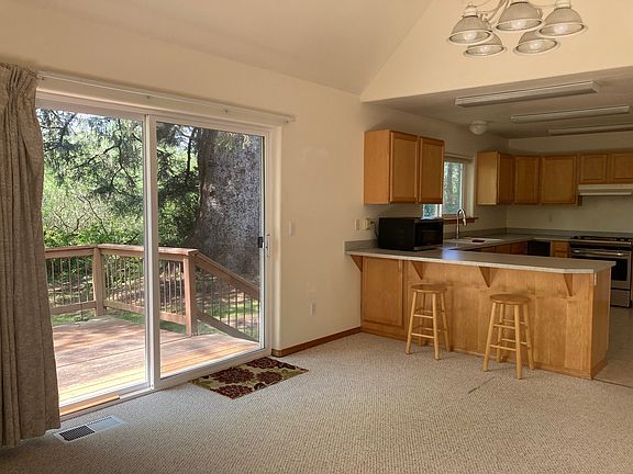 Dining room and kitchen with view of deck