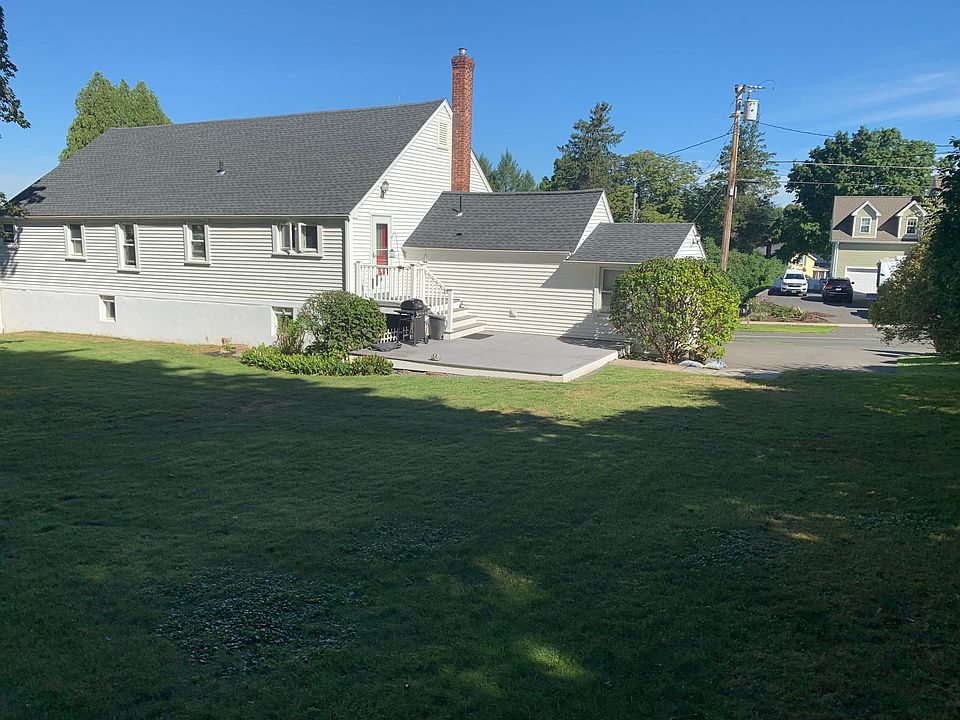 Back yard view to deck, entrance and driveway