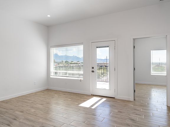LIVING ROOM AND BACK DOOR TO PATIO