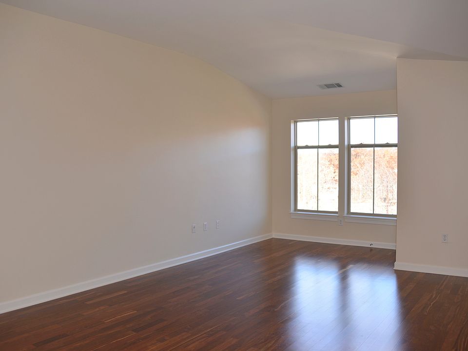 pacious Floor Plan with Vaulted Ceilings and Rosewood Floors