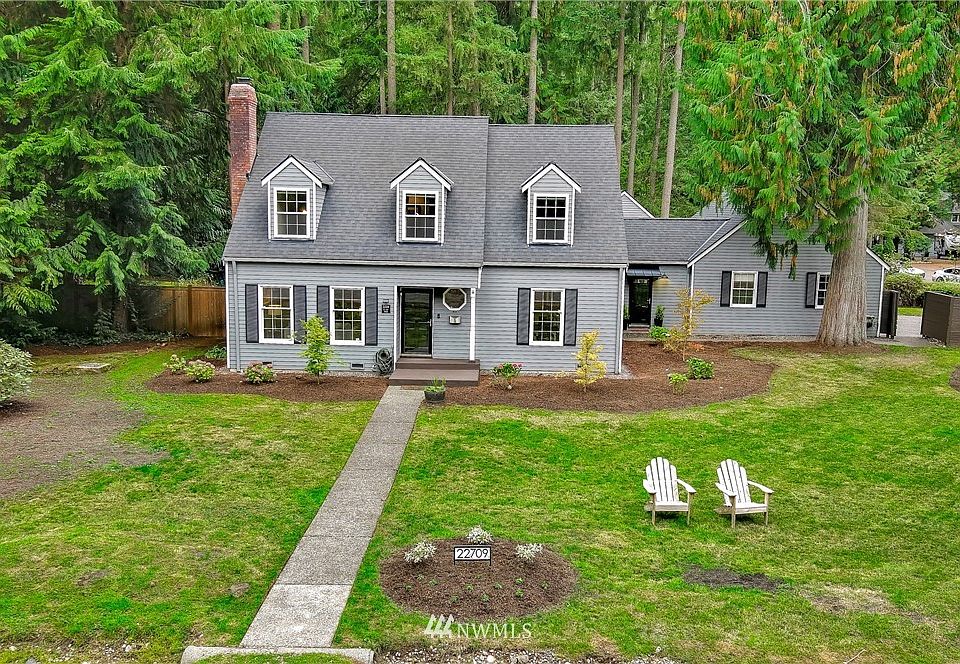 Positioned well back from the street, a quaint front walkway leads toward the front door of this spacious East Coast traditional style home.