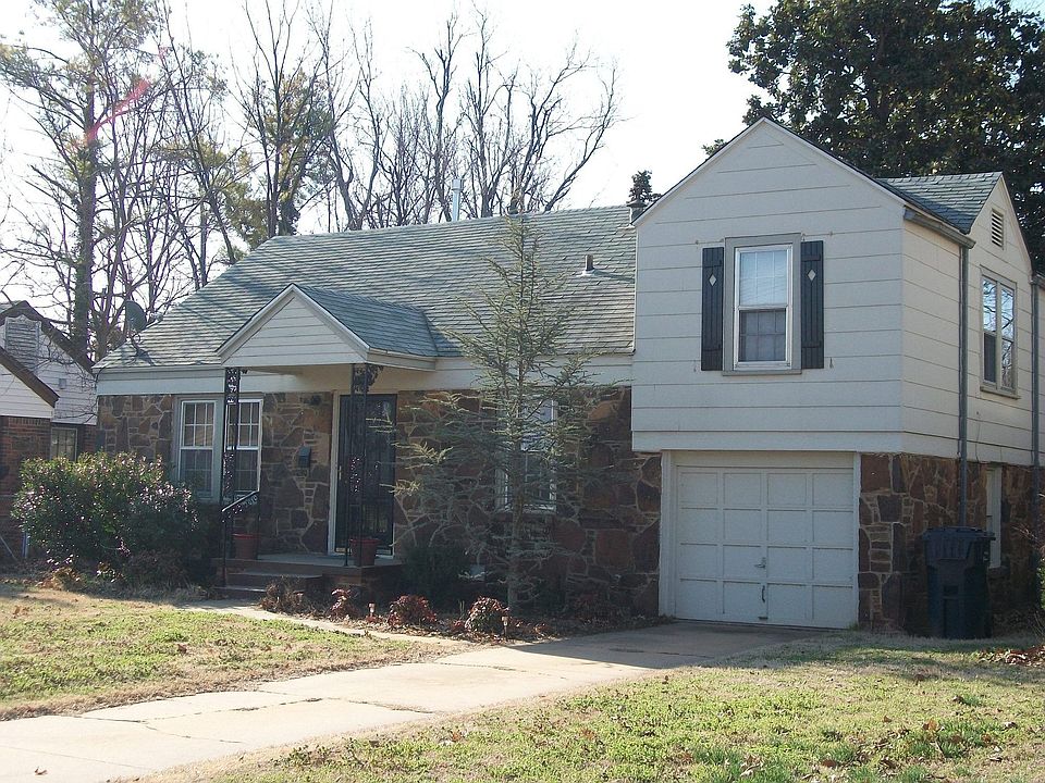 Beautiful rock exterior, small flower beds & tree bloom nicely in the spring.
