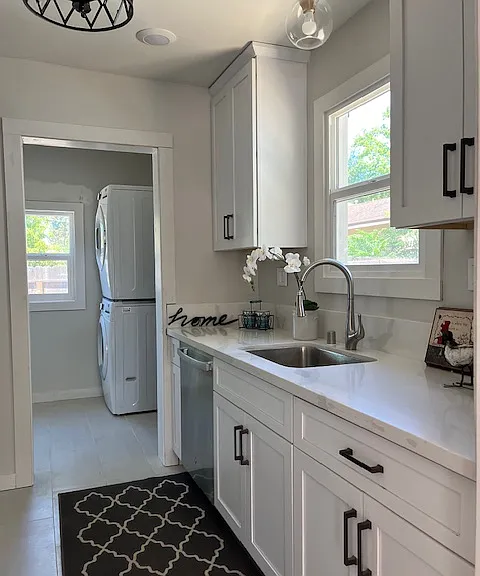 Beautiful and bright kitchen with brand new everything! Stainless steel appliances including gas stove, dishwasher, refrigerator, microwave hood. White shaker cabinetry and white quartz counter top and backsplash, white tile flooring, LED lighting.