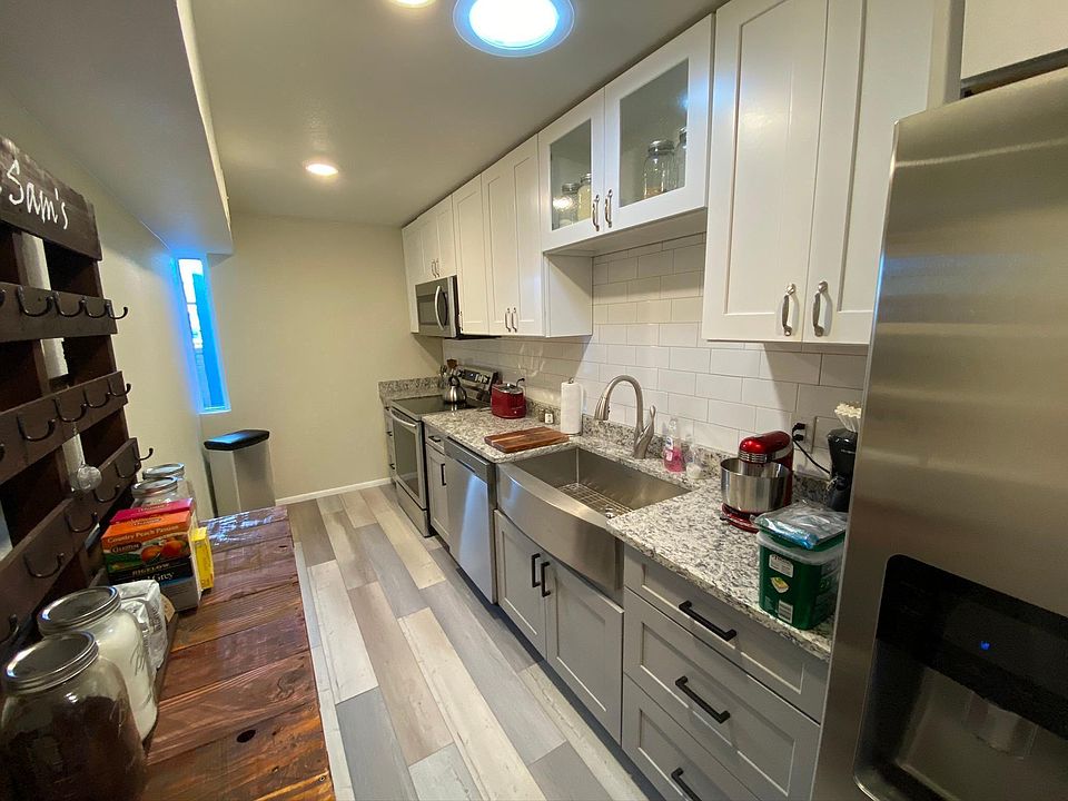 Highly funtional kitchen with stainless appliances and farm sink