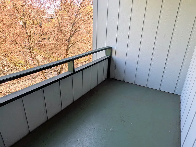 Balcony looks out over flowing trees