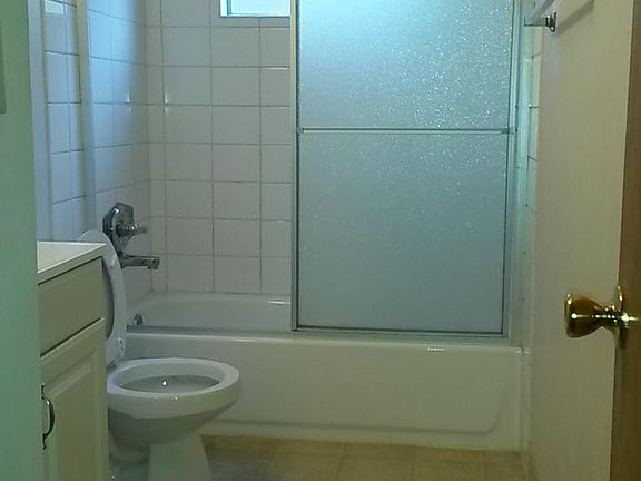 Bathroom with laminate floors, new tub and tile.