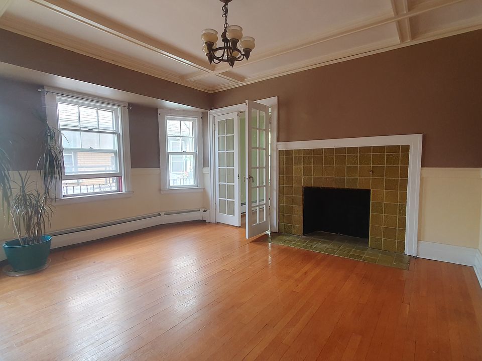 Dining room with bay windows and French doors. Fireplace #2.