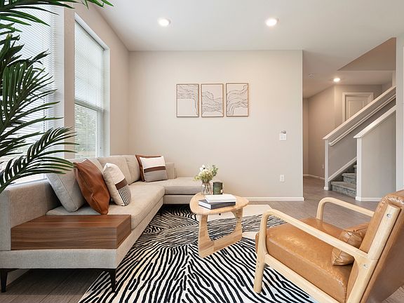 Chic, bright living room with cozy sofa, stylish decor, and natural light. Perfect for families & travelers. Near parks, DIA and hospitals. Comfortable, modern space for your stay. Book now!