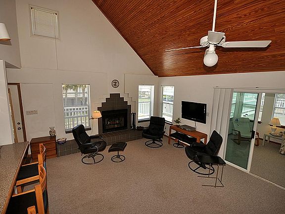 Living area with wood burning fireplace and water views