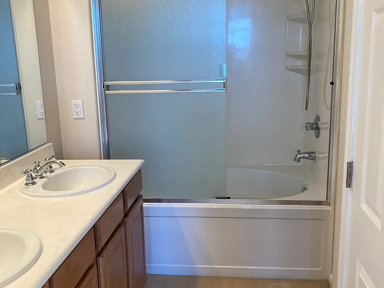 Master Bathroom with double sink vanity and shower over tub