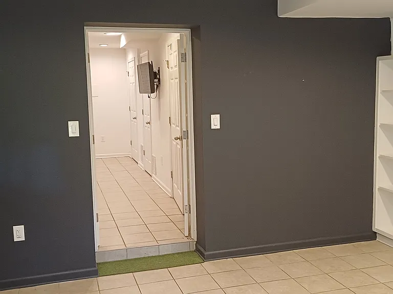 View from den/office/guest room to family room. Door to outside immediately to the left.