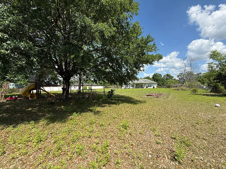 Mature shade trees and space for gardening and recreation in the backyard