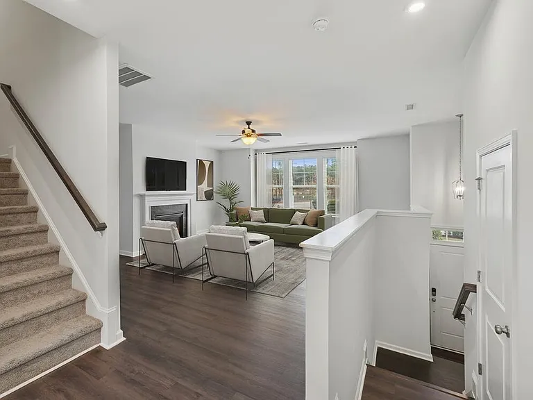 Upgrade Package Living room with hard-surface vinyl plank flooring throughout and fireplace