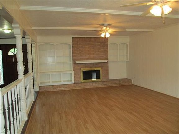 The opposite end of the living room has built-ins and a wood-burning fireplace. (Gas starter)