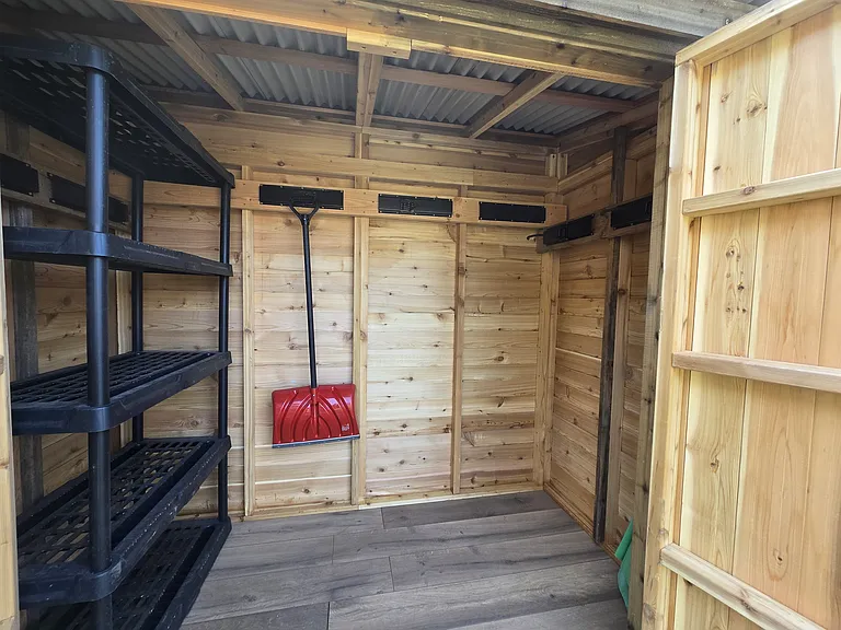 Hangers for bikes, etc. can be configured as desired. You can see the green patio table umbrella peeking out in the corner. Shelving optional.