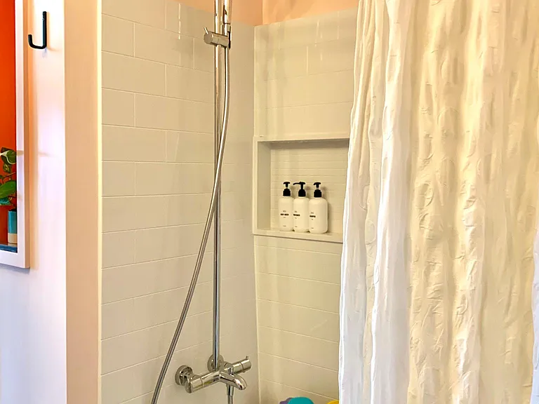 New tub and tile surround and amazing Hans Grohe waterfall shower and handheld shower. The shower is tall enough for those 6'+ tall.