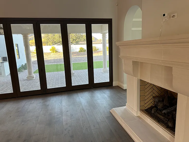 Great room fireplace, door system, patio with misters, and turf panel