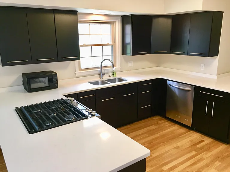 The kitchen features brand new quartz countertops, stainless steel appliances and espresso cabinets with ample storage