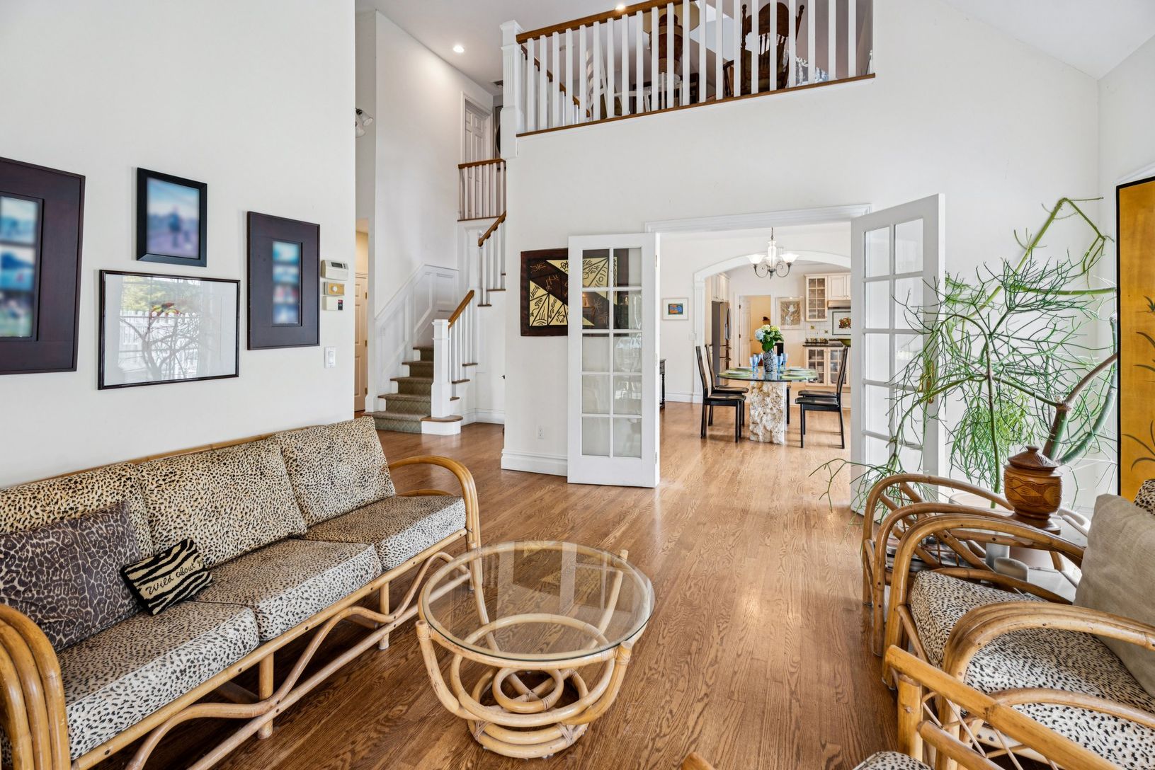 An expansive living area showcasing rich oak flooring and a dramatic cathedral ceiling.