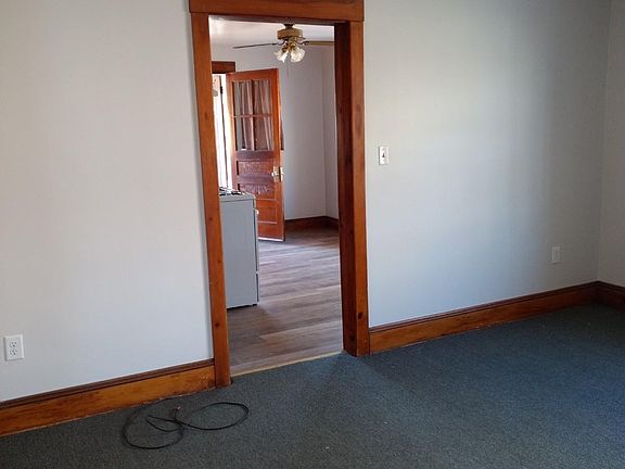 view into kitchen with new floors and refrigerator, gas stove