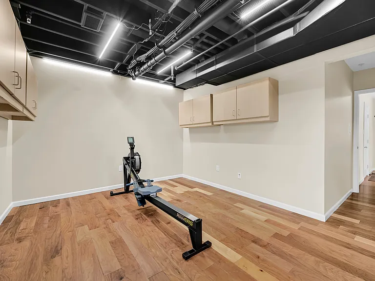 Finished Walkout Basement with wall mounted storage cabinets