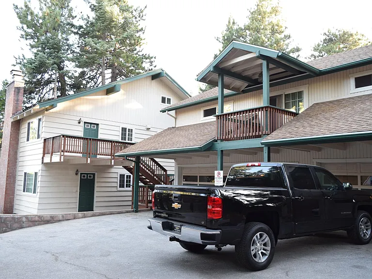 This unit is part of a triplex and has plenty of parking space. This picture shows you the rear entrance.