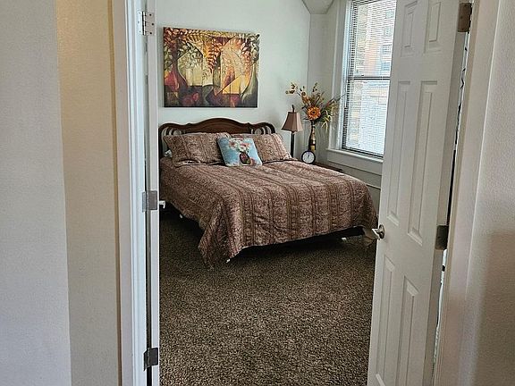 Enter the Master Suite with Queen sized bed and master bathroom and walk in closet.