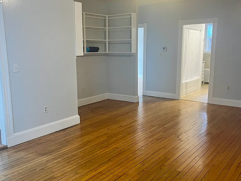 Hardwood floors and built-in shelves for TV/library or perfect space for a desk!