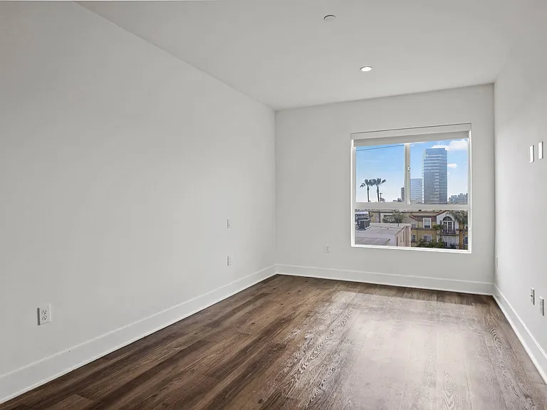 Bedroom with Large Windows and Vinyl Flooring