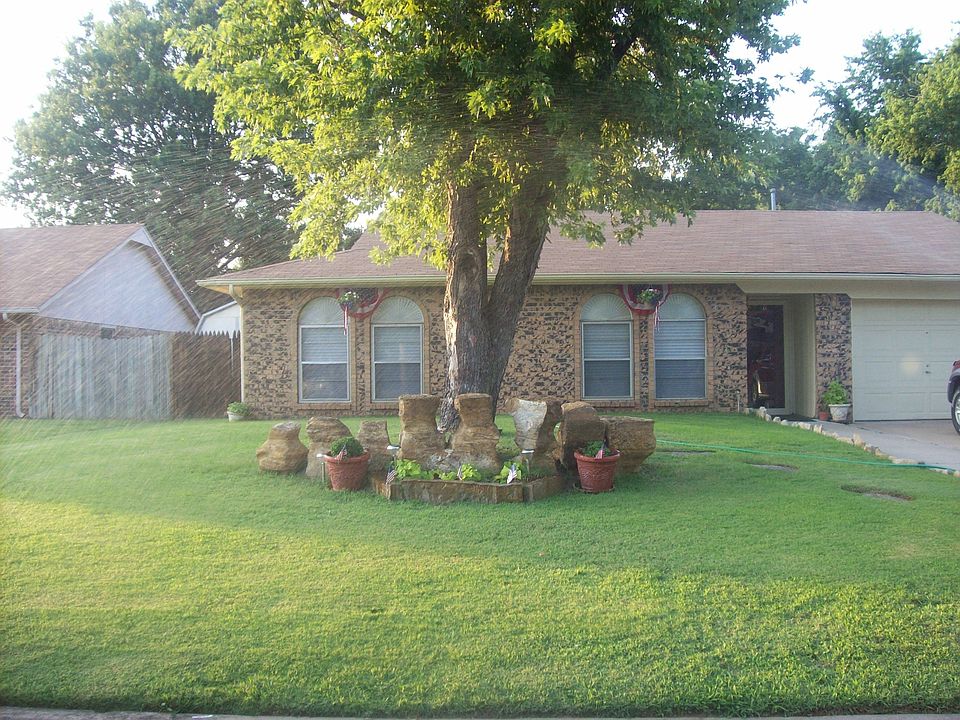 Home has a native rock landscaping and manicured lawn