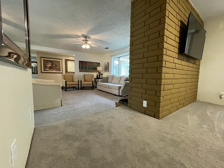 View from formal dining room into living room facing south with lots of natural light