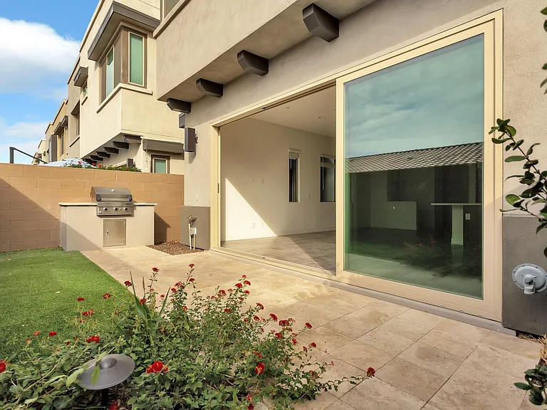 Pretty flowers and synthetic grass make the backyard area very easy to maintain.