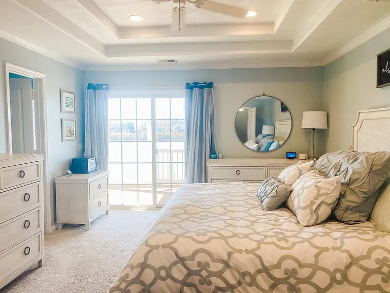 Master bedroom with private balcony overlooking the lake.
