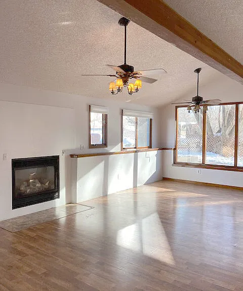 The Great-Room. Open, airy....vaulted ceiling- eating area on the south side of the room. 2 ceiling fans with light fixtures.