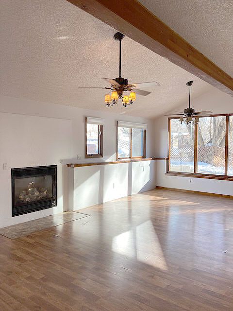 The Great-Room. Open, airy....vaulted ceiling- eating area on the south side of the room. 2 ceiling fans with light fixtures.