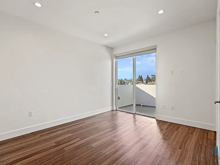 Living Room with Vinyl Flooring, Recessed Lighting, and Patio