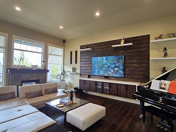 Living room with large windows and gas fireplace.